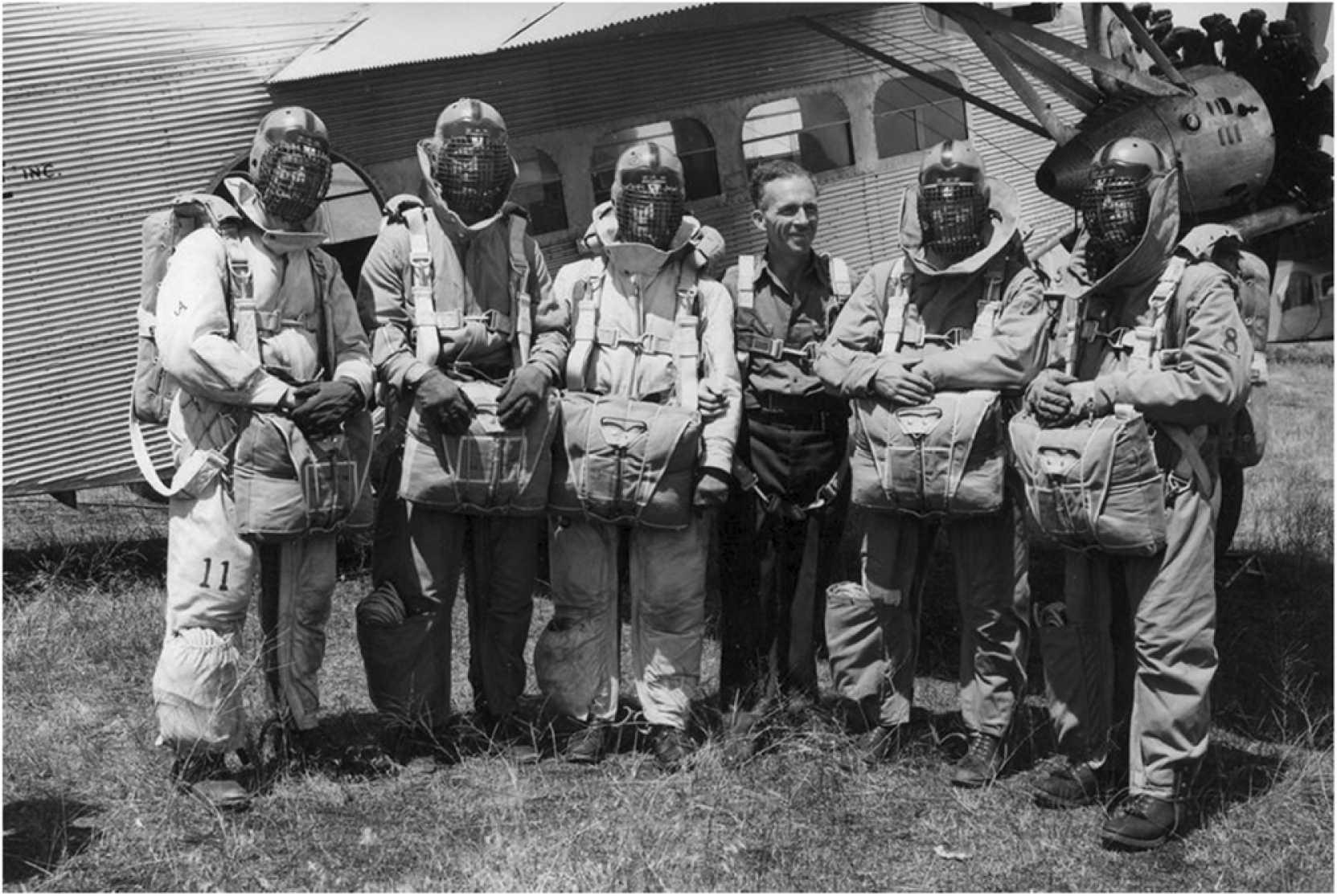 Smokejumpers parachuting into a forest fire